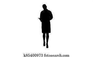 Silhouette Young doctor woman reading documentation while walkin Silhouette Young doctor woman reading documentation while walkin