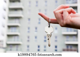 A real estate agent holding keys to a new apartment in her hands.