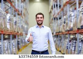 happy man at warehouse showing thumbs up gesture happy man at warehouse showing thumbs up gesture