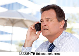 Businessman Smiles as He Talks on His Cell Phone