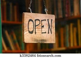 Retail and shopping image of an open sign in a book store window Retail and shopping image of an open sign in a book store window
