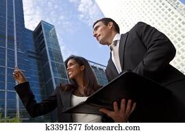 Interracial Male and Female Business Team In Modern City Interracial Male and Female Business Team In Modern City