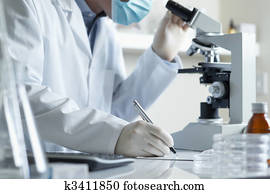 Scientist conducting research with microscope 