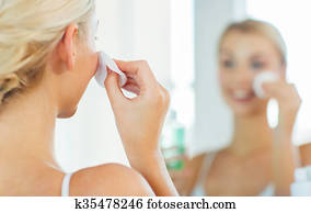 close up of woman cleaning face at bathroom close up of woman cleaning face at bathroom
