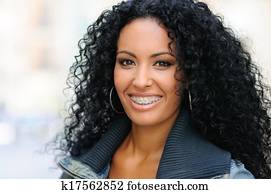 Young black woman smiling with braces Young black woman smiling with braces