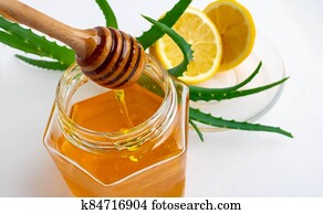 Useful ingredients for strengthening the immune system on a white background.Honey in a jar, lemon and aloe Vera. Space for text Useful ingredients for strengthening the immune system on a white background.Honey in a jar, lemon and aloe Vera. Space for text