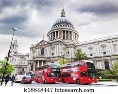 St Paul's Cathedral in London, the UK. Red buses, cloudy sky
