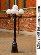 Antique Style Street Lamp in front of Brick Wall