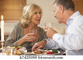 Couple Enjoying A Meal At Home Together Couple Enjoying A Meal At Home Together