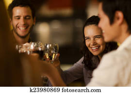 Group of friends toasting with wine