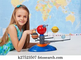Young girl study solar system in science class