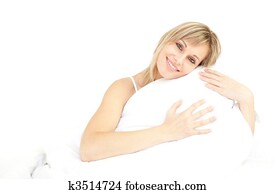 Smiling woman hugging her pillow 