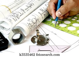 Draftsman with engineering plans Draftsman with engineering plans