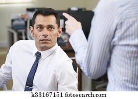 Businessman Being Shouted At By Female Colleague