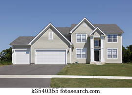 Home with tan siding and arched entry