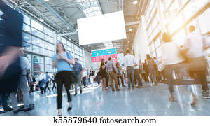Blurred trade fair visitors walking in hall Blurred trade fair visitors walking in hall
