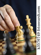 Hand moving knight on chess board