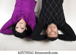 Happy couple lying down on floor