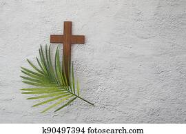 Palm sunday background. Cross and palm on grey background.