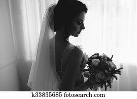 Bride posing in a large window Bride posing in a large window