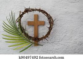 Palm sunday background. Cross and palm on grey background.