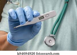 hand holding digital thermometer. hand holding digital thermometer.