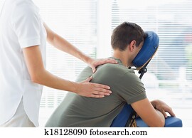 Physiotherapist giving massage to man Physiotherapist giving massage to man