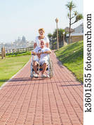 wife pushing husband in wheelchair