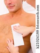 Man waxing his chest hair Man waxing his chest hair