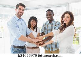 Happy coworkers joining hands in a circle