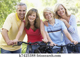 Family Cycling Through A Park Family Cycling Through A Park