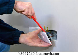 Electrician installing a socket Electrician installing a socket