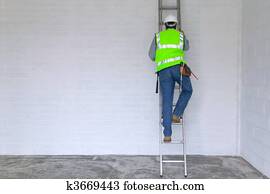 Workman climbing a ladder
