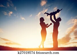 Happy family together, parents with their little child at sunset. Happy family together, parents with their little child at sunset.