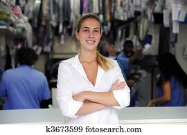 happy owner of a dry cleaning business happy owner of a dry cleaning business