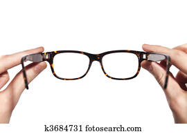 glasses with horn-rimmed in human hands isolated 