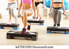 Group of smiling people lifting barbells