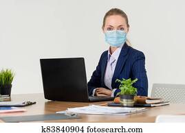 Office worker with face mask quarantine from coronavirus or COVID-19. Office worker with face mask quarantine from coronavirus or COVID-19.