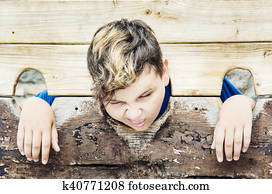 Young caucasian boy in medieval pillory