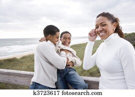 African-American family laughing at beach