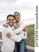 African-American father and son laughing at beach