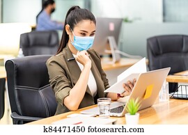 Asian businesswoman working in new normal and social distance office
