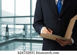Businessman signing a document Businessman signing a document