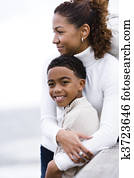 Close-up of African-American mother hugging son