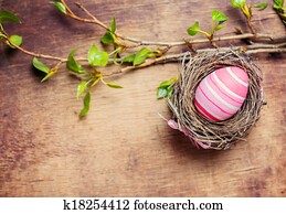 Easter egg in nest on wooden background Easter egg in nest on wooden background