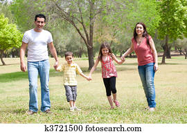 Family posing to camera in the park