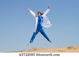 intern jumping on beach
