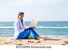 pretty indian intern using laptop 