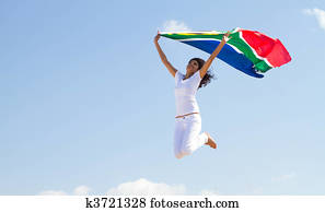 woman jumping holding flag