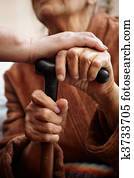 adult helping senior in hospital